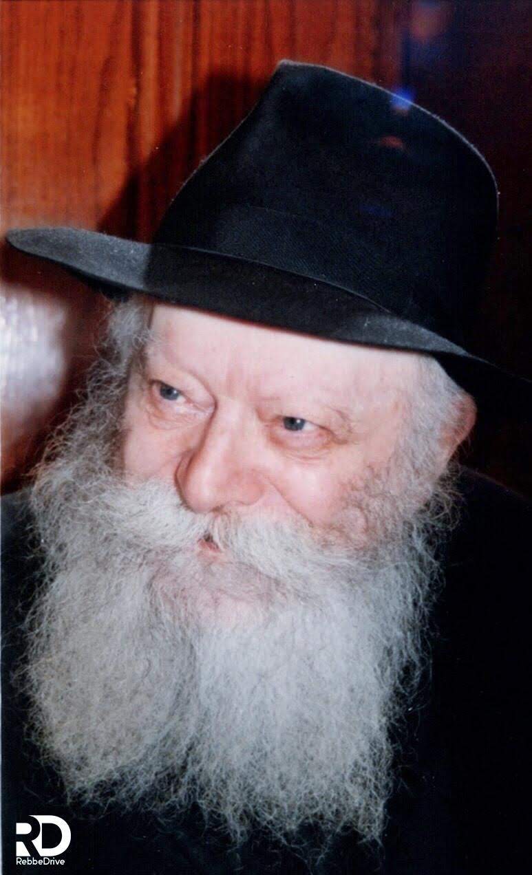 A close portrait of the Lubavitcher Rebbe, Rabbi Menachem M. Schneerson, wearing his black hat.